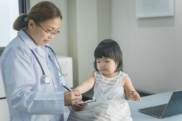 Asian doctor has a stethoscope to check his breathing and heart of a lovely girl, check the health of children,Thailand people