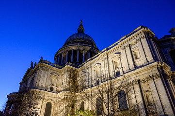 Fototapeta na wymiar St. Paul's Cathedral in London, UK. Evening view of St Paul's taken from the southeast of the cathedral. Illuminated building and clear dark blue sky