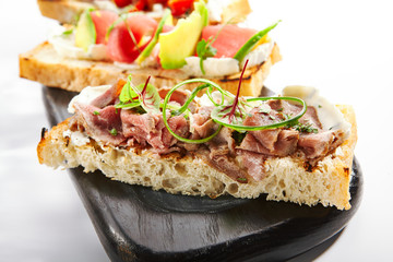 Bruschetta with pastrami closeup view