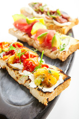 Delicious bruschetta with baked peppers closeup view