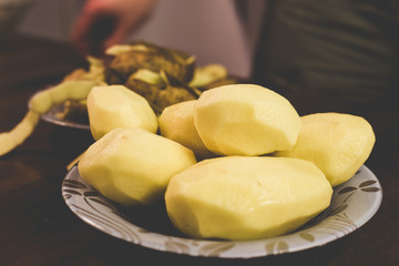 Peeling potatoes with a knife at home