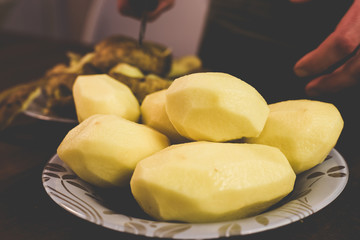 Peeling potatoes with a knife at home