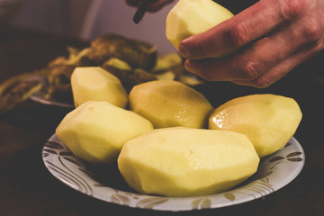 Peeling potatoes with a knife at home