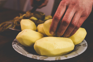 Peeling potatoes with a knife at home