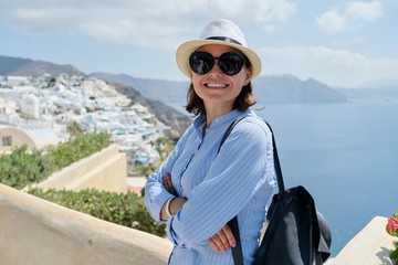 Fototapeta na wymiar Happy mature woman tourist traveling on famous island Santorini