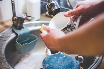 My dishes under running water with a paralon sponge