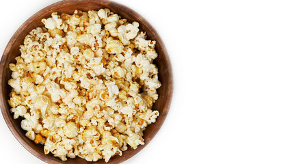 photo sweet popcorn on a white background wooden bowl top view