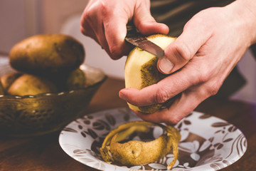 Peeling potatoes with a knife at home