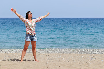 Fototapeta na wymiar woman on the beach by the sea