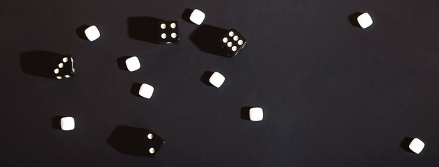 The dice are scattered on a black cloth. Concept