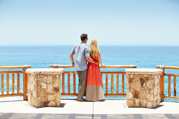 Young couple looking at the ocean in Mexico