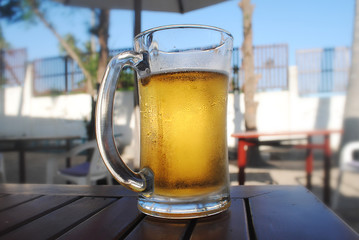 Glass of light beer on a summer pub.