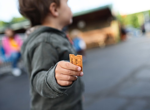 Child Holds Ticket For Theme Park