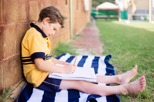 Young boy with homework outside after school