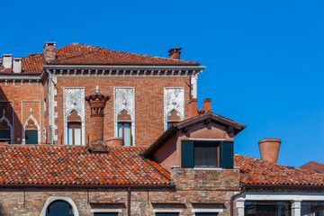 Obraz premium Venice, Ancient brick chimneys above the roofs