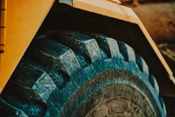 Fotobehang Vrachtwagen large tractor tire up-close  © Alexandr Ivaschenko