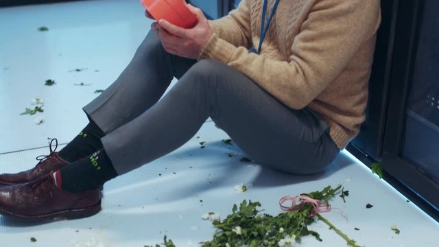 Sad Valentine's Day. Lonely IT specialist sitting on floor in despair holding a present box from valentine regret about quarrel fight staying at server room data center.