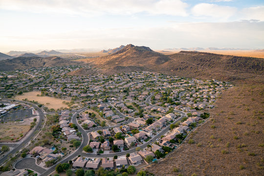 An aerial view of a desert community surrounded by mountains