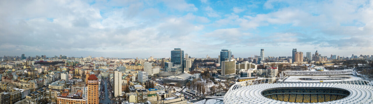 Panoramic drone view of city and stadium.