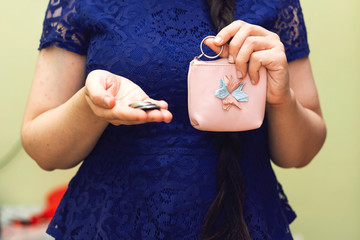 closeup woman holding coin from her wallet for donation, donate concept