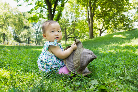Japanese toddler girl portrait on a grass in summer
