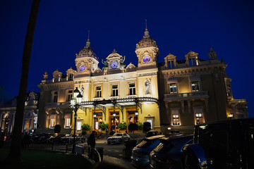 Obraz premium MONACO, FRANCE - FEBRUARY 11, 2019: Casino in Monaco. Night landscape. Monte Carlo. Casino Monte-Carlo in the night, night illumination, luxury cars, players, tourists.