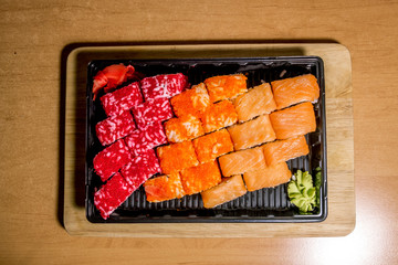 A set of  sushi neatly laid out on a wooden surface