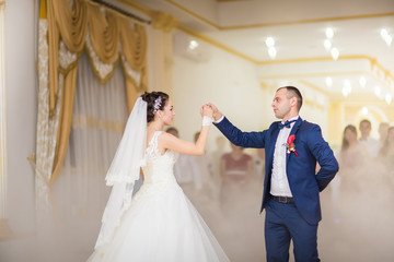 elegant brides in the restaurant dance their first wedding dance