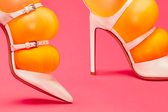 Close up of orange inflated balloons in stilettos