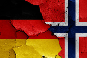 flags of Germany and Norway painted on cracked wall