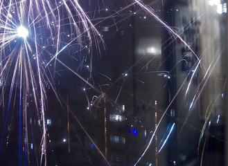 A closeup shot of festive fireworks spreading happiness in the night sky