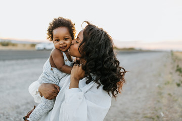 An African American mother and her child outdoors.