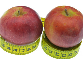 red apple with measuring tape isolated on white background