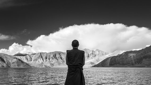 Tibetan Monk By The Lake In A Mountains