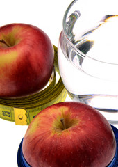 red apple with measuring tape isolated on white background