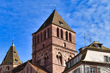 Fototapeta na wymiar Tower of old historical Lutheran St Thomas Church, also called 'Eglise Saint Thomas' n French in Strasbourg city in France