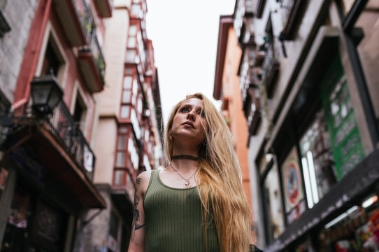 Blonde woman looking forward tattooed.