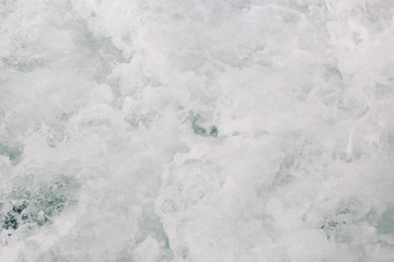 seething sea foam from a wave that broke on a rock. natural sea background