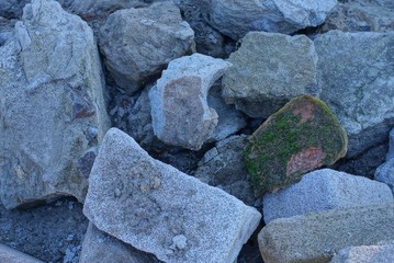 gray texture of large old stones in a heap on the street