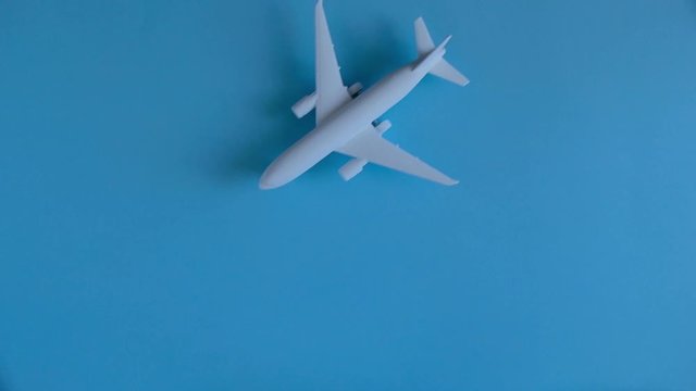 concept of vacation, tourism, travel, toy airplane on a blue background