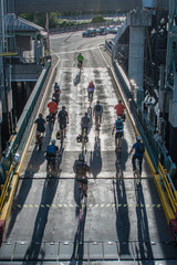 cyclist leaving ferry with shadows