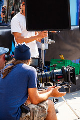 Focus puller hold the wireless follow focus system during the filming process...