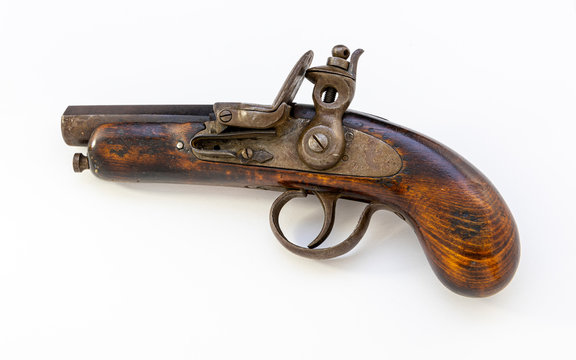 A photograph of a vintage pistol on a white background