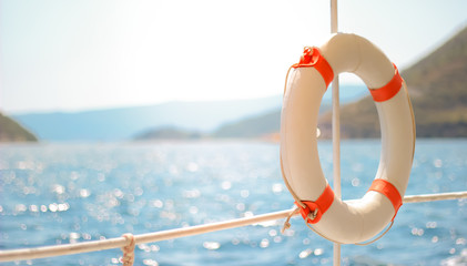 A lifebuoy hangs against the sky and sea