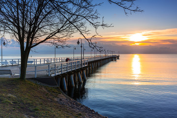 Fototapeta na wymiar Beautiful landscape with wooden pier in Gdynia Orlowo at sunrise, Poland