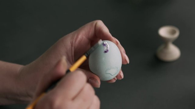 painting eggs for Easter. Painting with oil and bru