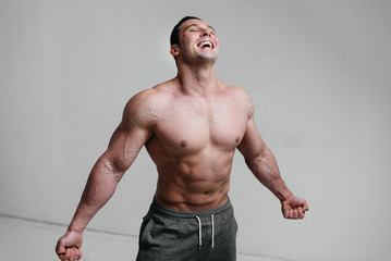 Sexy athlete posing on a white background Topless. Fitness