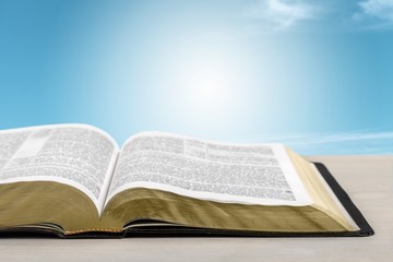 Holy Bible book on a wooden desk