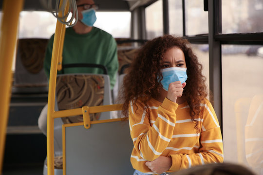 African-American woman with disposable mask on bus. Virus protection