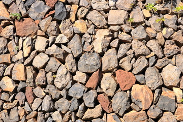 Texture of a red orange granite stone wall for background